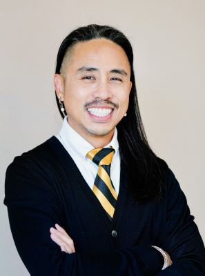 Man with long hair smiling