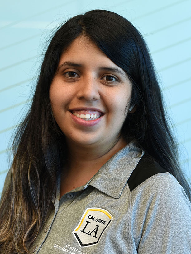 A person with long hair smiling