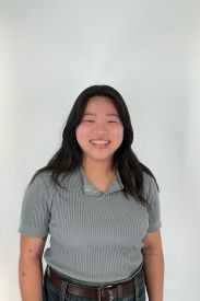 Student with short black-hair smiling