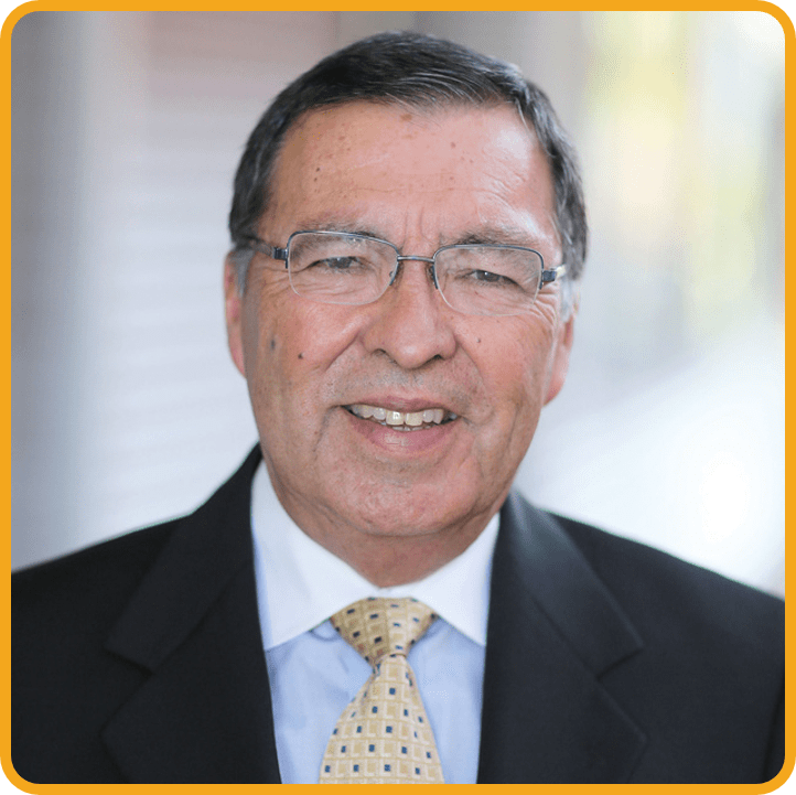 Headshot of Raul Cardoza. He is smiling and wearing a black blazer with a yellow tie.