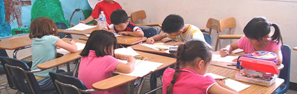 children working on a desk