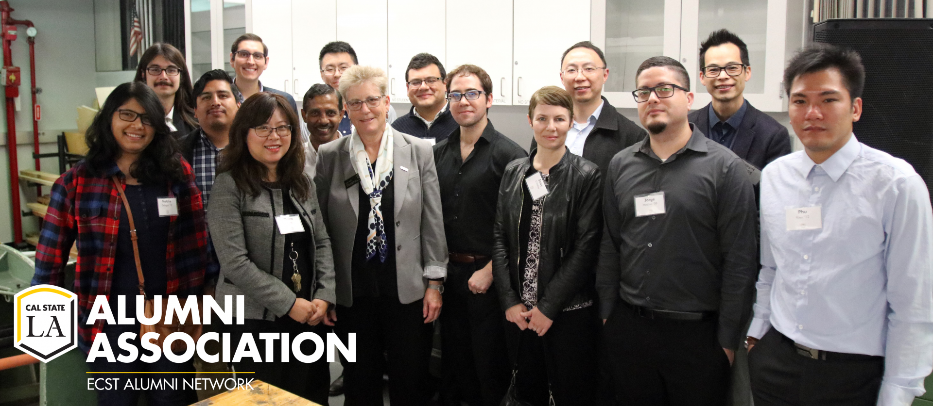 14 Cal State LA alumni, students, staff and faculty posing with ECST Dean, Emily Allen, at the ECST Makerspace lab on 2/18/20. 