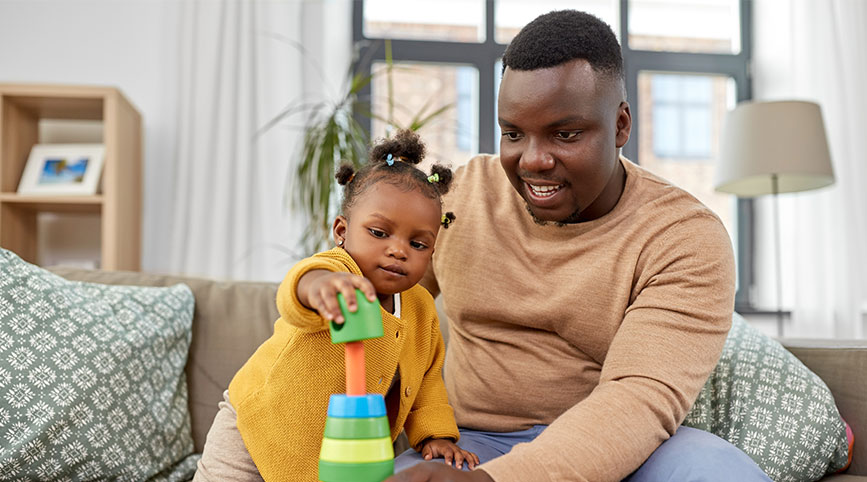 A dad plays with his daughter 