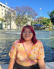 Lizbeth Vargas-Martinez sitting in front of fountain.