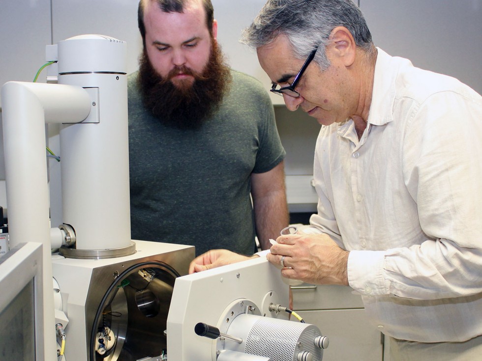 People working with a machine in a lab