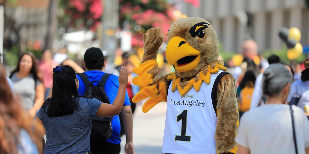 eddie the eagle high 5's student on walkway