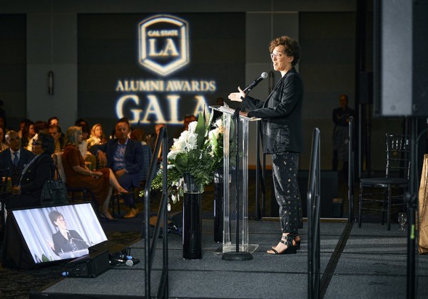 2024 Alumni Awards Gala presenter on stage.