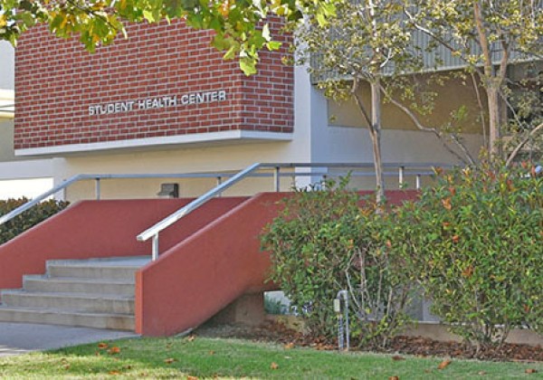 Exterior of a brick building with a sign "Student Health Center."