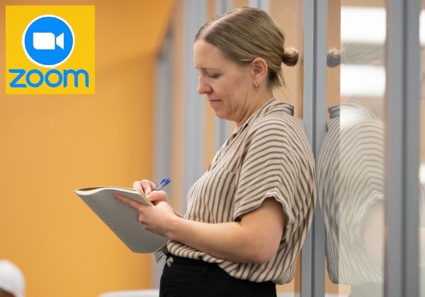 Woman writing on paper standing up 