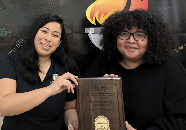 marylu and sonia from honors college holding plaque