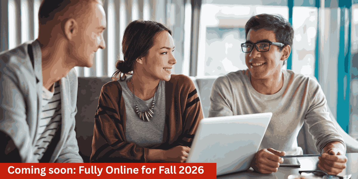 three people in office boardroom talking and looking at a laptop