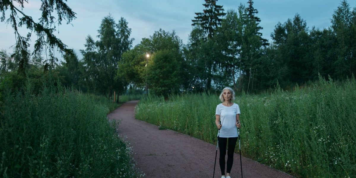 Woman in field with crutches