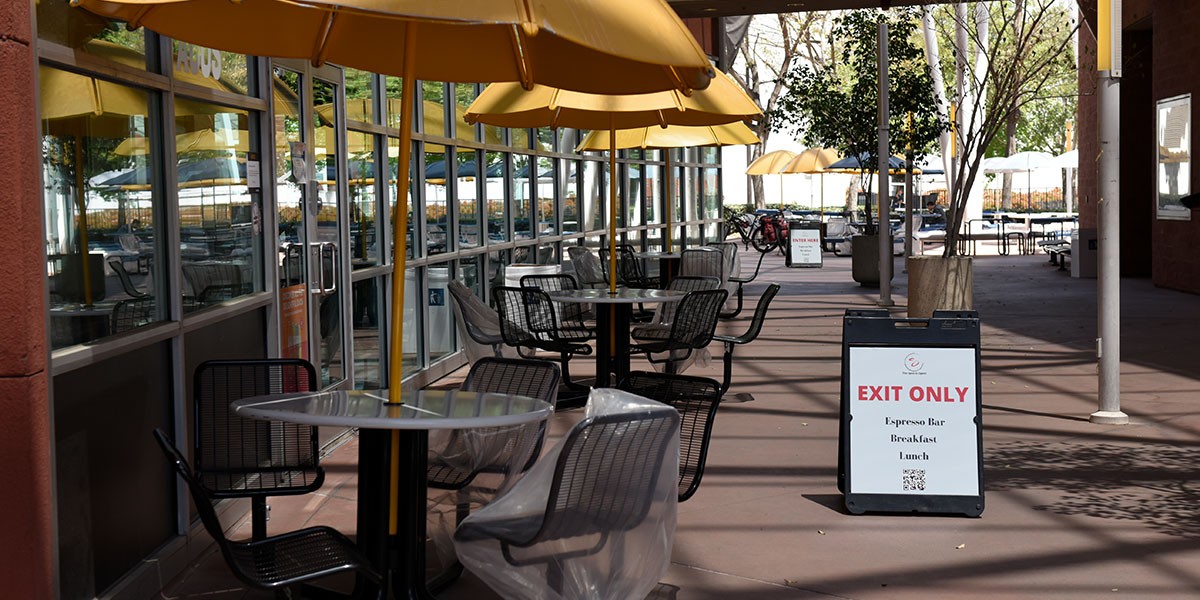 Covered chairs at outdoor tables to help with social distancing