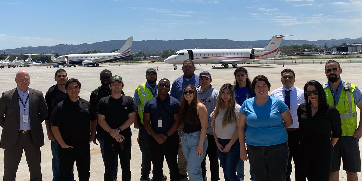 rachel friedman with students at airfield with planes