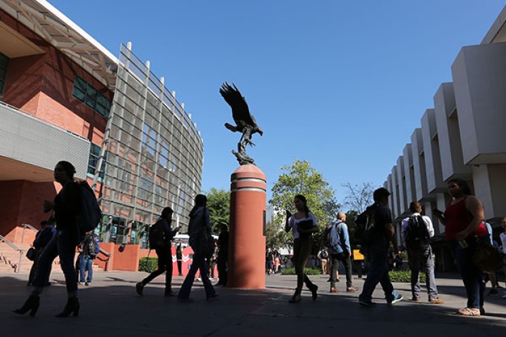 Students walk nearby Golden Eagle statue