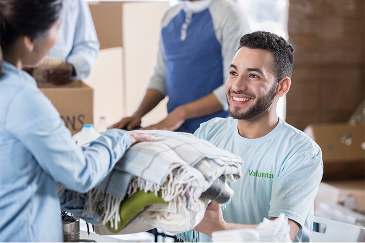 Image of woman donating to social services volunteer