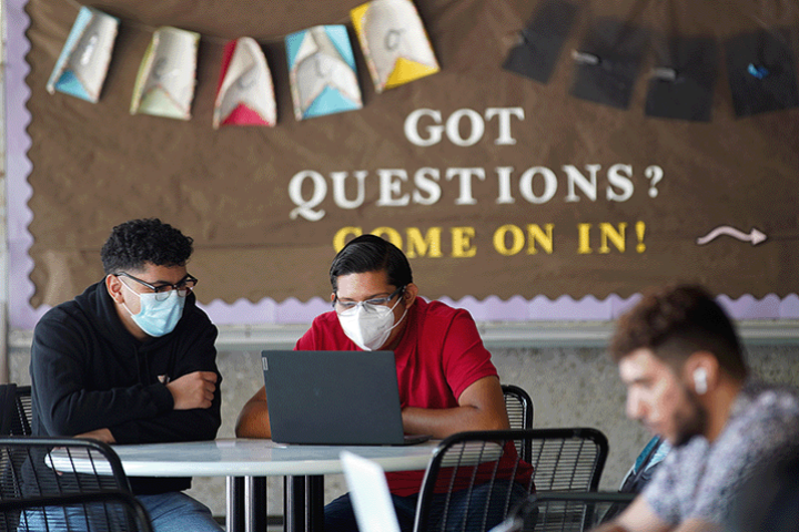 Two students reading a syllabus together