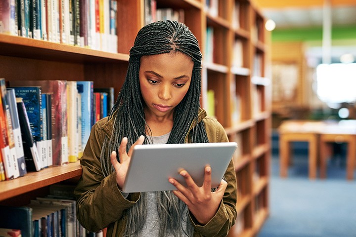 Student holding an iPad.