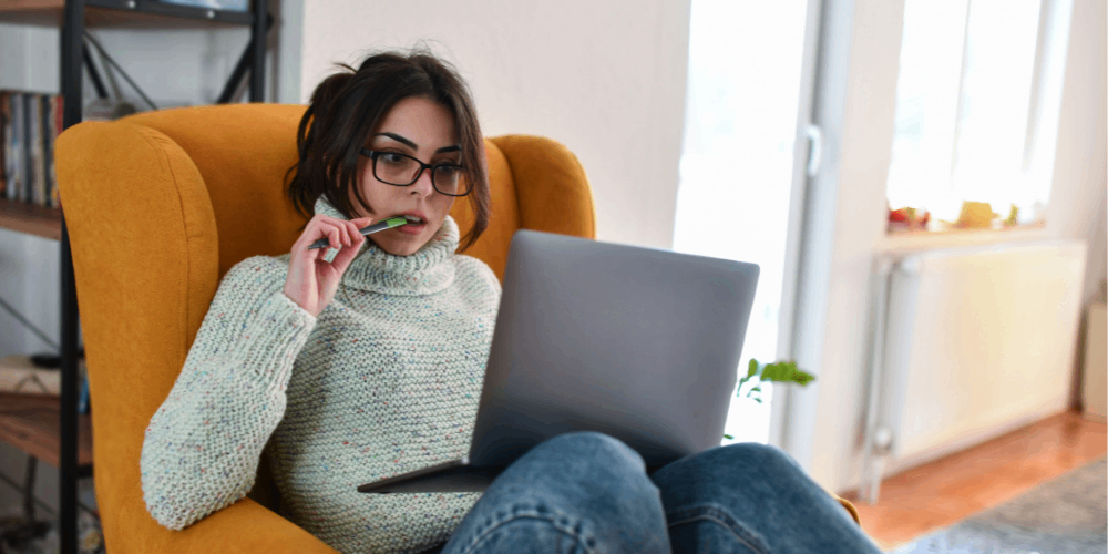Female student sitting in chair with laptop