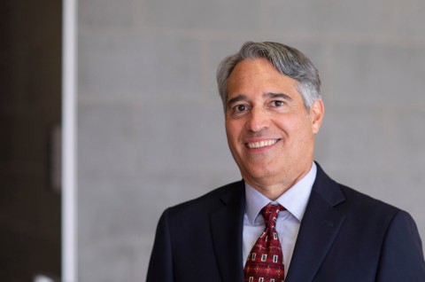 Man with red tie and dark blue suit 