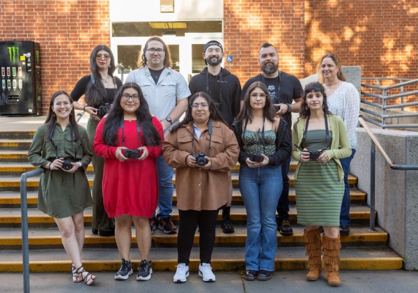 10 students from the Anthropological Film class standing together holding cameras in their hands