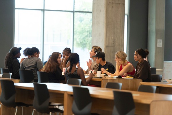 A group of students eating and talking.