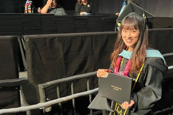 female graduate holding diploma