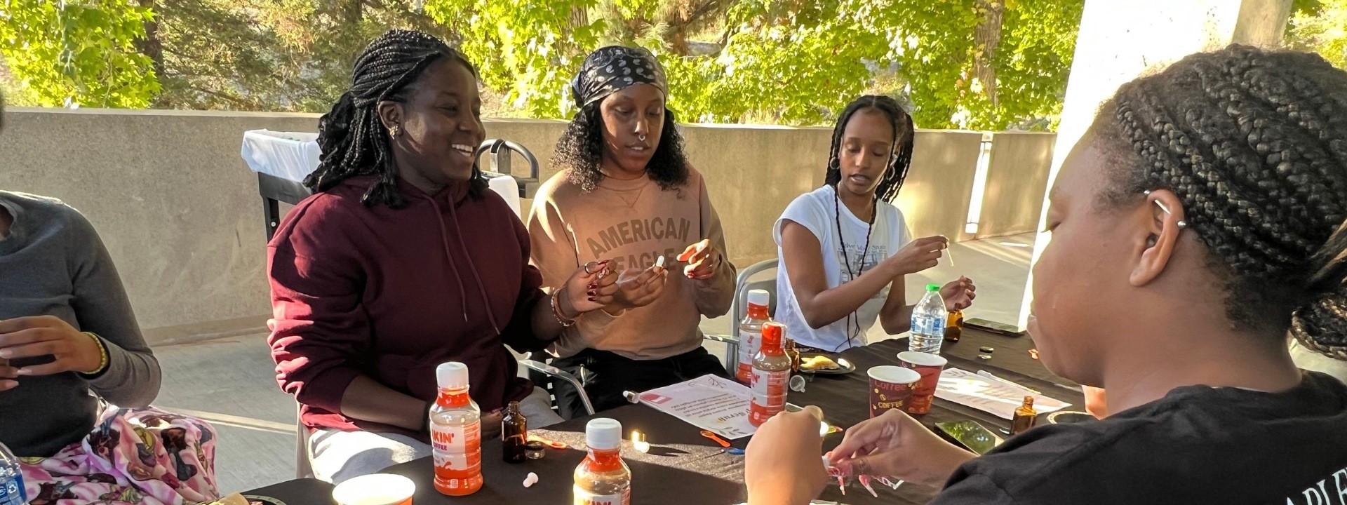 A group of students smiling and observing a spray bottle.