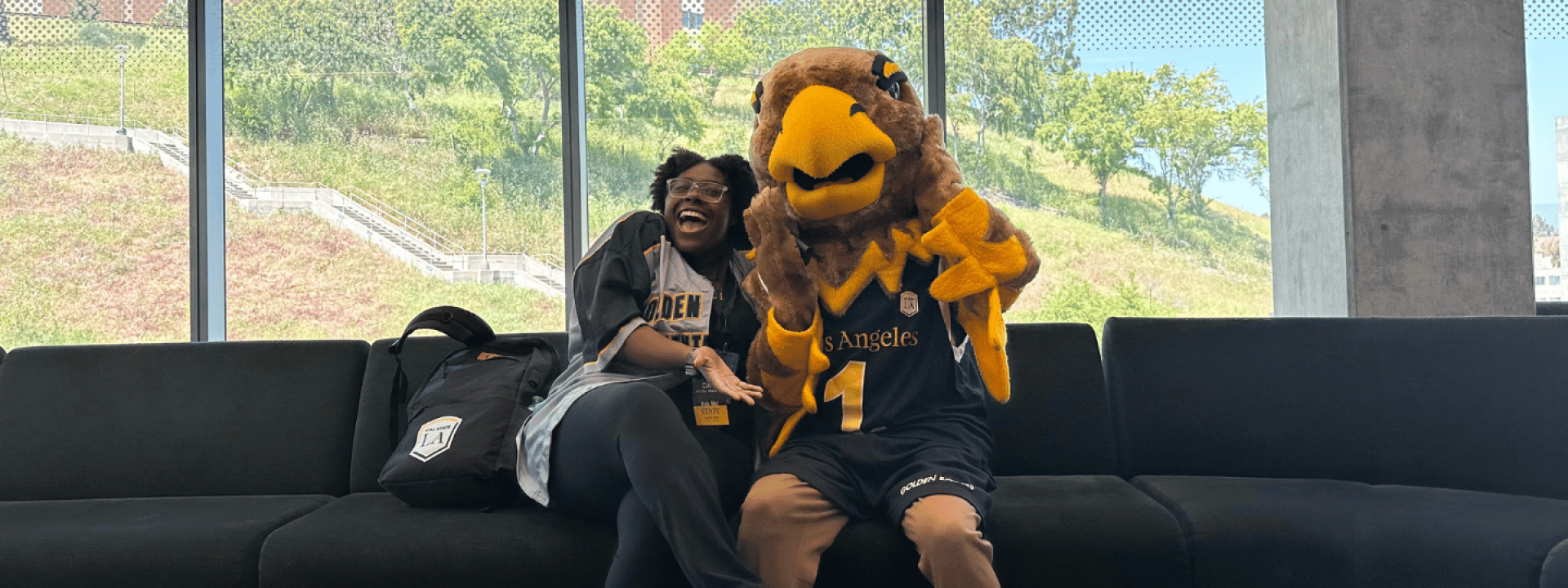 Eddie the Golden Eagle and a student in Housing.