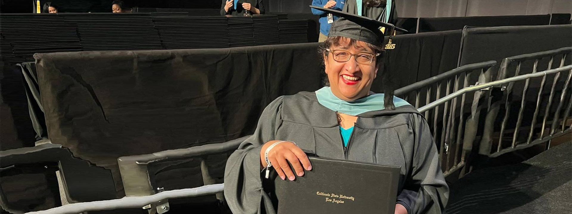 female graduate holding diploma