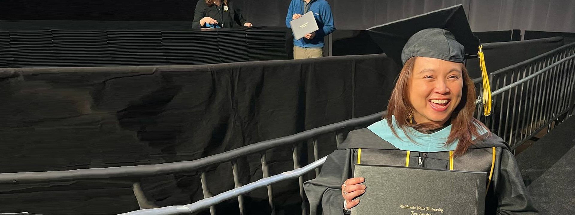 female graduate holding diploma