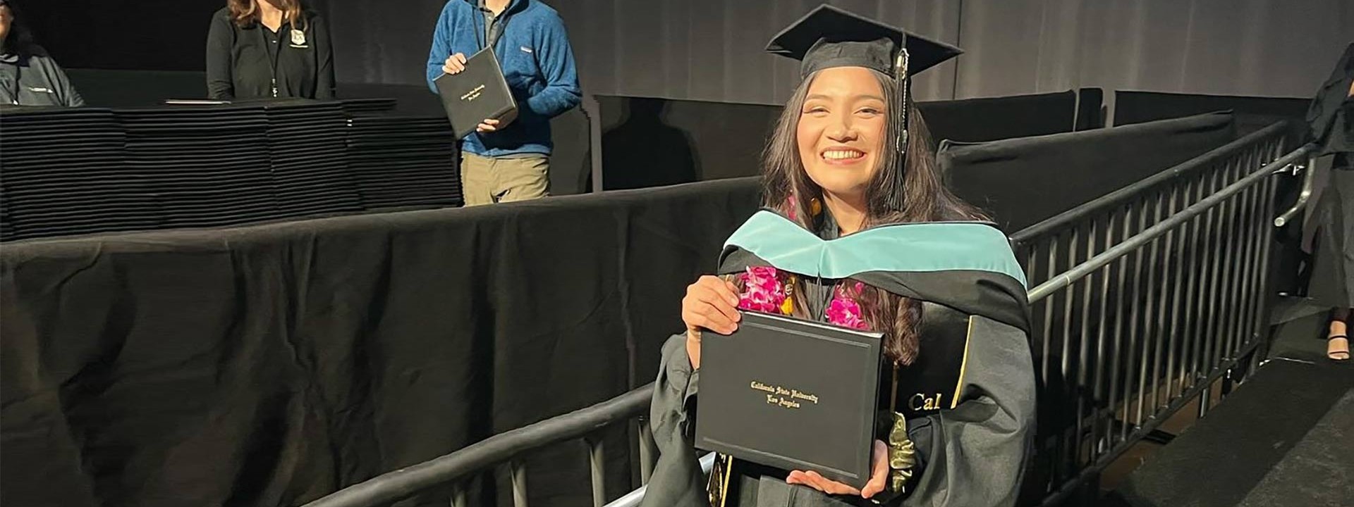 female graduate holding diploma