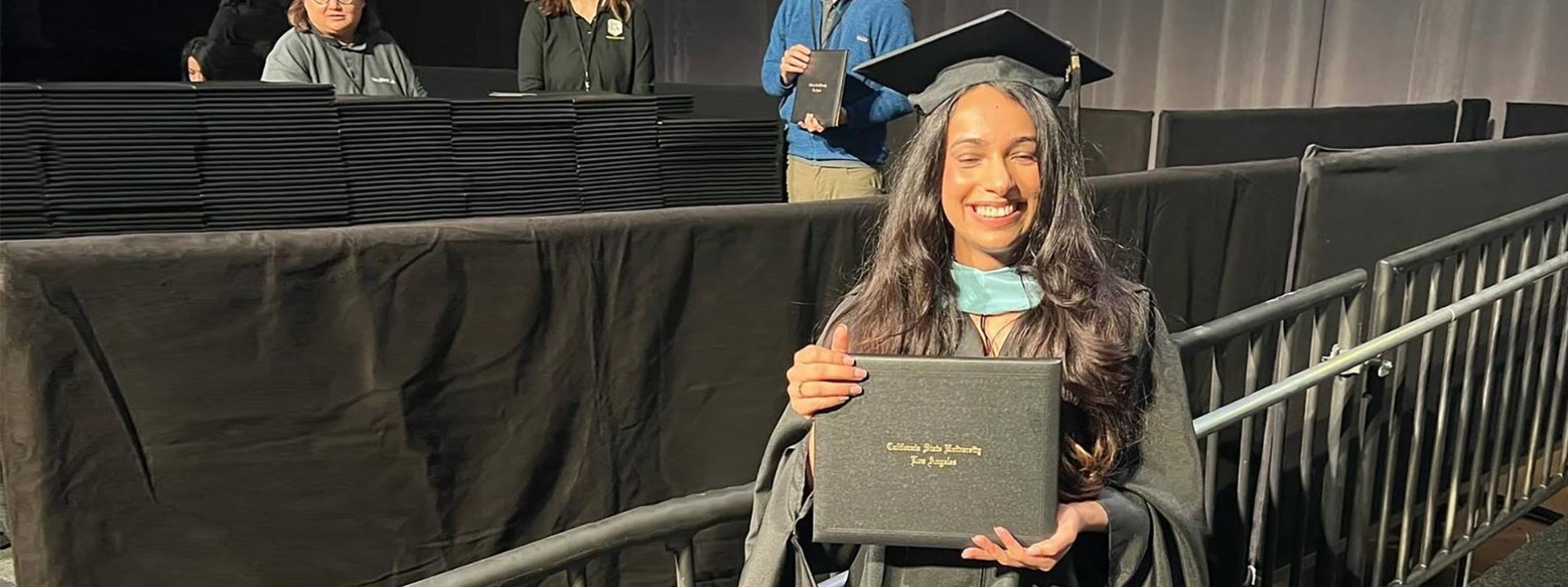 female graduate holding diploma