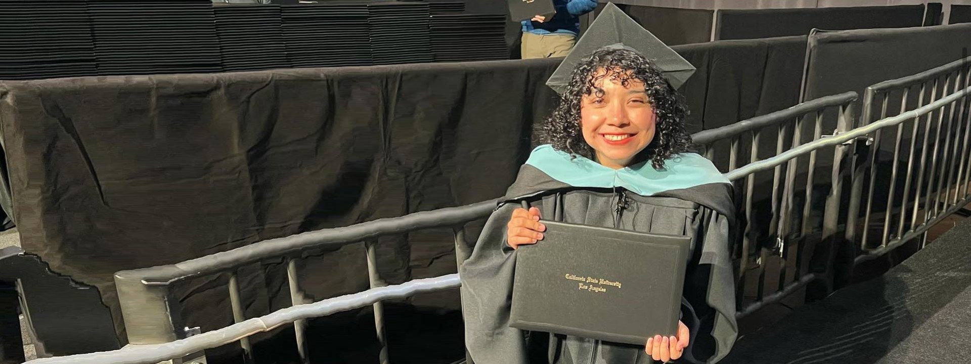 female graduate holding diploma